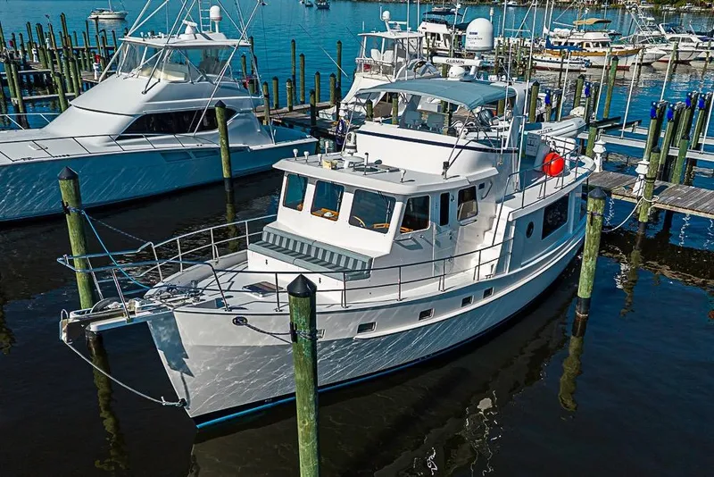 Slide: The Image of 2019 Kadey-Krogen 44 AE yacht docked at marina, surrounded by other boats. - 3