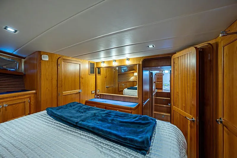 Slide: The Image of Luxurious 2019 Kadey-Krogen 44 AE yacht cabin with wooden interior and cozy bedding. - 30