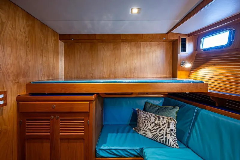 Slide: The Image of 2019 Kadey-Krogen 44 AE yacht interior with wooden finish and blue seating. - 37