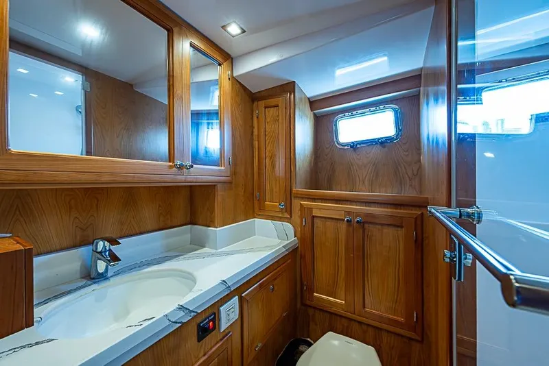 Slide: The Image of Luxurious 2019 Kadey-Krogen 44 AE yacht bathroom with wood cabinetry and modern fixtures. - 41