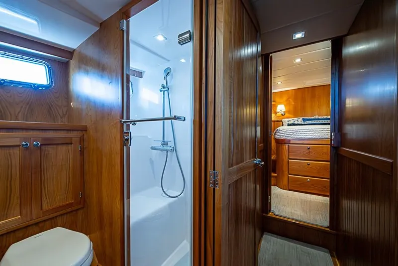 Slide: The Image of Luxurious 2019 Kadey-Krogen 44 AE yacht interior with wooden bathroom and cozy bedroom. - 42