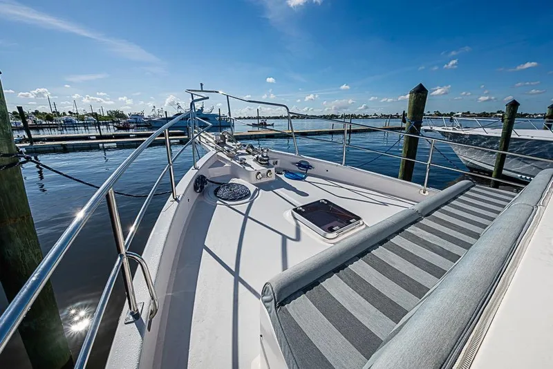 Slide: The Image of 2019 Kadey-Krogen 44 AE yacht deck with marina view under clear blue sky. - 51
