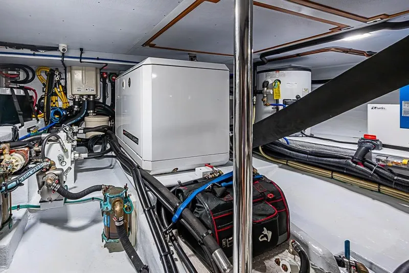 Slide: The Image of Engine room of 2019 Kadey-Krogen 44 AE yacht with mechanical equipment and wiring. - 68
