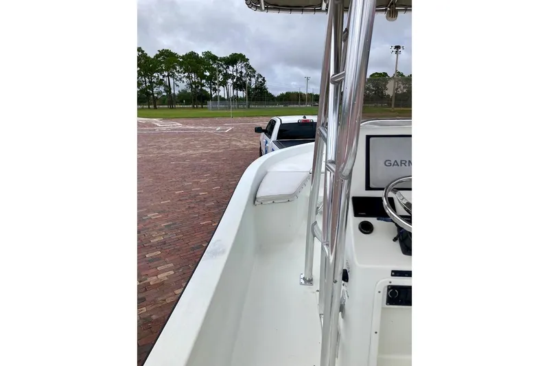 Slide: The Image of 2007 Action Craft Coastal Bay 2310 boat with Garmin navigation, parked on brick pavement. - 17