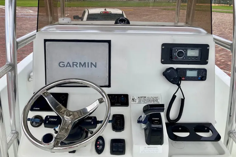 Slide: The Image of 2007 Action Craft Coastal Bay 2310 boat dashboard with Garmin navigation and Yamaha controls. - 18