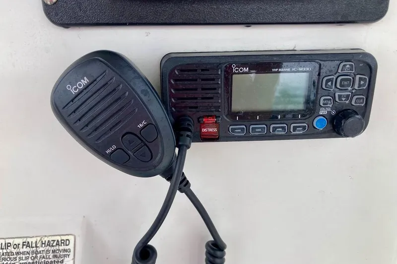 Slide: The Image of Icom VHF marine radio on 2007 Action Craft Coastal Bay 2310 boat dashboard. - 21