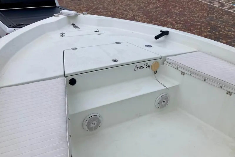Slide: The Image of 2007 Action Craft Coastal Bay 2310 boat interior with seating and storage compartments. - 23