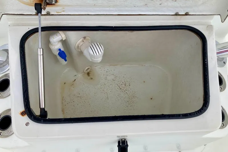 Slide: The Image of Livewell compartment on a 2007 Action Craft Coastal Bay 2310 boat, featuring plumbing and hydraulic support. - 33