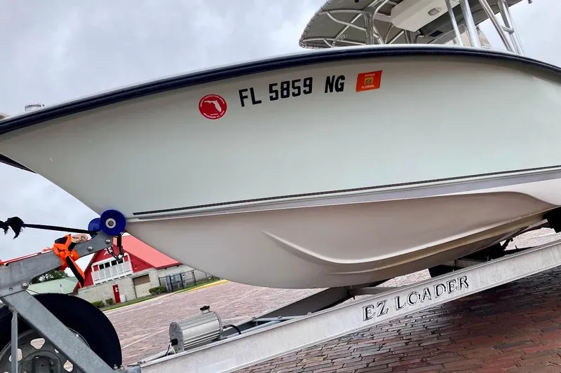 Slide: The Image of 2007 Action Craft Coastal Bay 2310 boat on EZ Loader trailer, parked on brick pavement. - 6