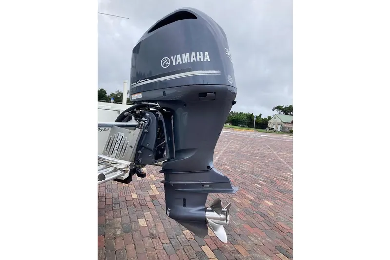 Slide: The Image of 2007 Action Craft Coastal Bay 2310 with Yamaha outboard motor on brick pavement. - 9