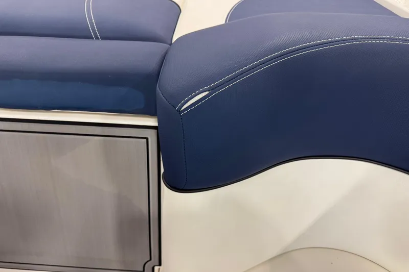 Slide: The Image of 2019 MasterCraft XT25 boat interior with blue cushioned seating and sleek design. - 10