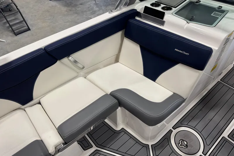 Slide: The Image of 2019 MasterCraft XT25 boat interior with blue and white seating, modern design. - 13