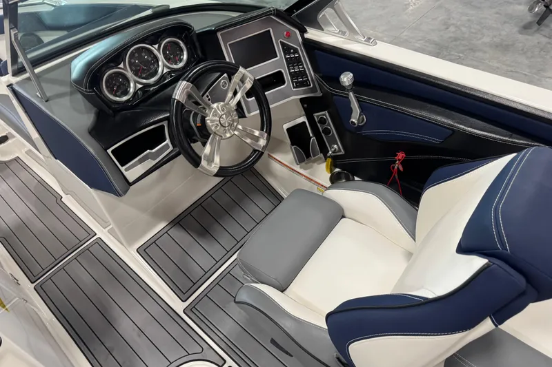 Slide: The Image of 2019 MasterCraft XT25 boat interior with modern dashboard and luxurious seating. - 14