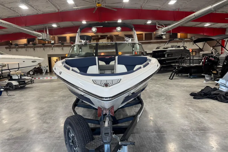 Slide: The Image of 2019 MasterCraft XT25 boat in showroom, front view, on trailer. - 5