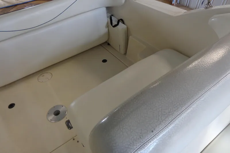 Slide: The Image of Interior seating of a 2000 Sea Ray 240 Sundancer boat, featuring cream upholstery. - 10