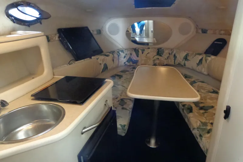 Slide: The Image of Interior of 2000 Sea Ray 240 Sundancer with kitchenette and seating area. - 14