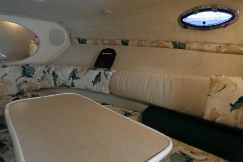 Slide: The Image of Interior of 2000 Sea Ray 240 Sundancer with floral upholstery and oval window. - 16