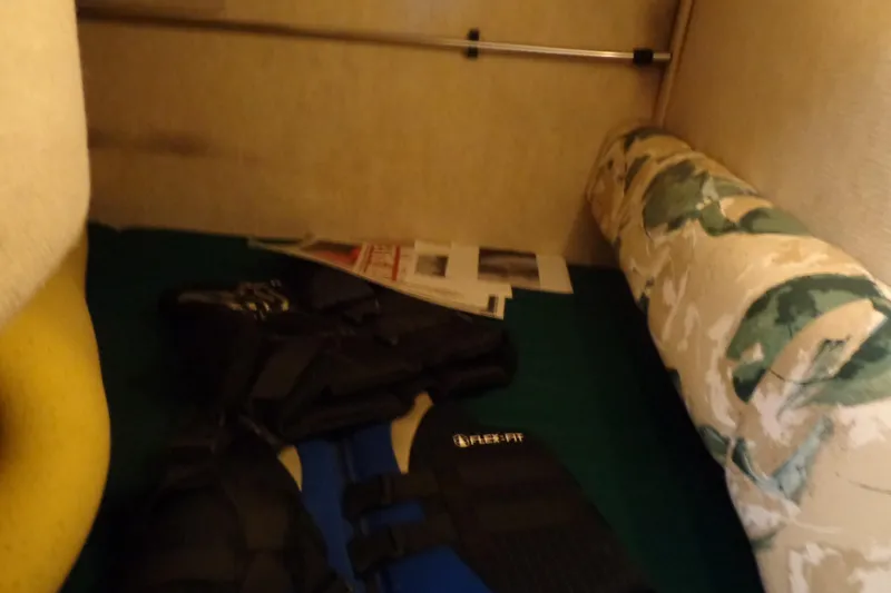 Slide: The Image of Interior of 2000 Sea Ray 240 Sundancer with life jackets and patterned cushion. - 19