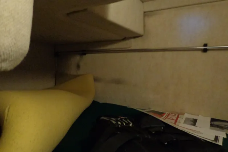 Slide: The Image of Interior cabin view of a 2000 Sea Ray 240 Sundancer boat with cushions and papers. - 20