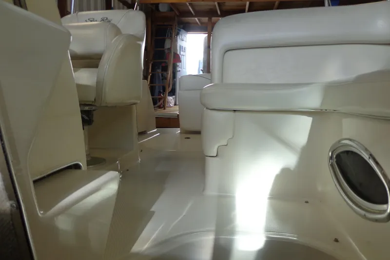 Slide: The Image of Interior of 2000 Sea Ray 240 Sundancer boat with beige seating and flooring. - 21
