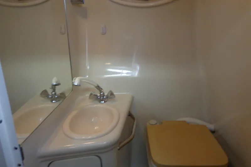 Slide: The Image of Bathroom interior of 2000 Sea Ray 240 Sundancer with sink and toilet. - 23