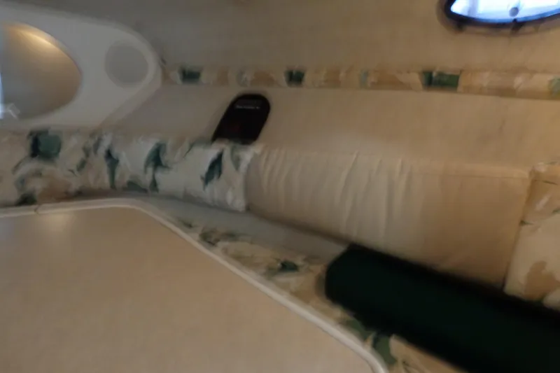 Slide: The Image of Interior cabin of 2000 Sea Ray 240 Sundancer with floral upholstery and table. - 24