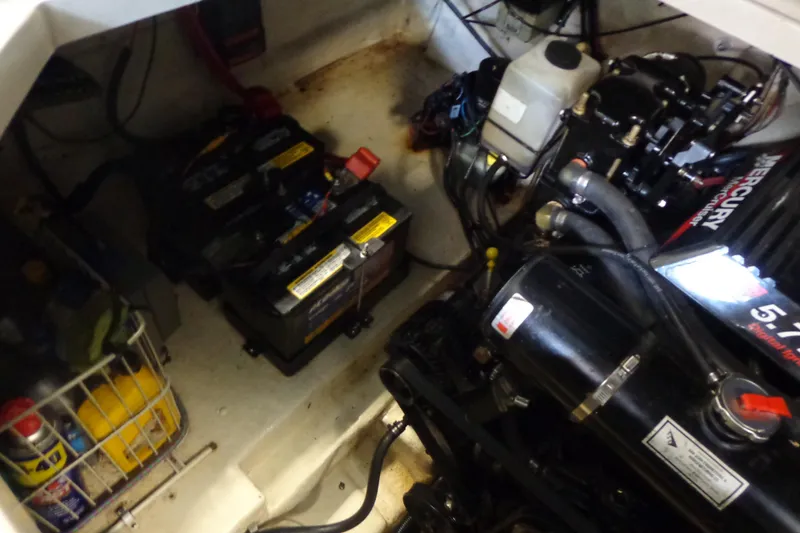 Slide: The Image of Engine compartment of a 2000 Sea Ray 240 Sundancer with batteries and Mercury engine. - 26