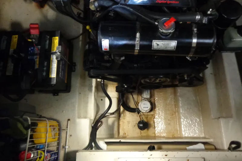 Slide: The Image of Engine compartment of a 2000 Sea Ray 240 Sundancer with visible batteries and wiring. - 27