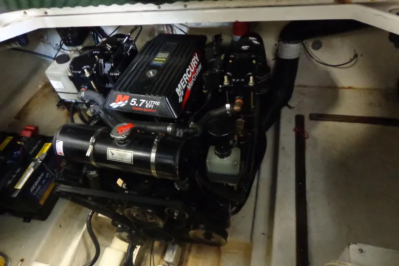 Slide: The Image of Engine compartment of a 2000 Sea Ray 240 Sundancer with a 5.7L Mercury engine. - 28