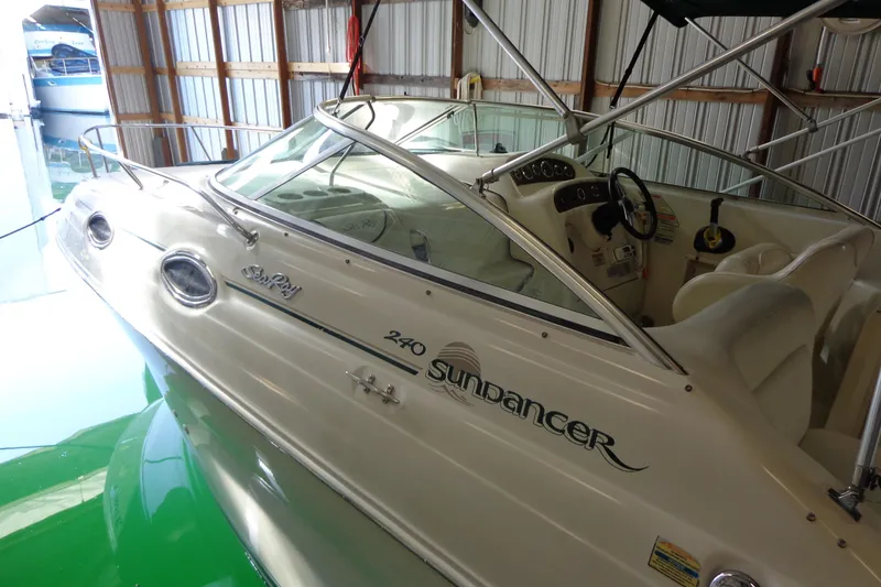 Slide: The Image of 2000 Sea Ray 240 Sundancer boat side view with logo and model name. - 3