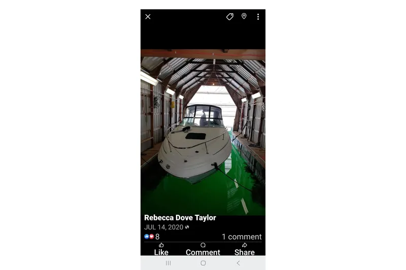 Slide: The Image of 2000 Sea Ray 240 Sundancer docked in a covered boathouse. - 31