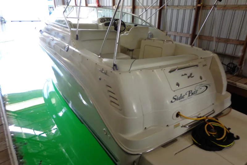 Slide: The Image of 2000 Sea Ray 240 Sundancer boat docked indoors with visible wiring and equipment. - 5