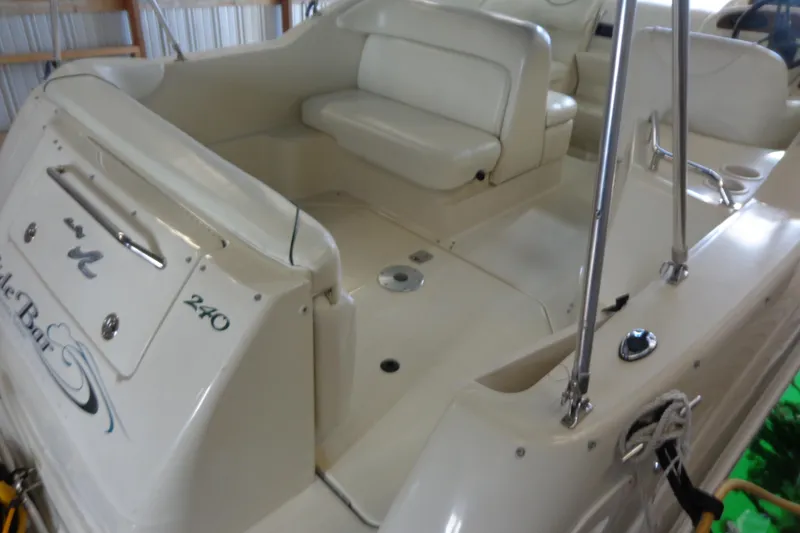 Slide: The Image of 2000 Sea Ray 240 Sundancer boat interior with seating and storage. - 6
