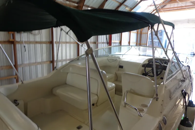 Slide: The Image of 2000 Sea Ray 240 Sundancer boat interior with canopy in storage. - 7