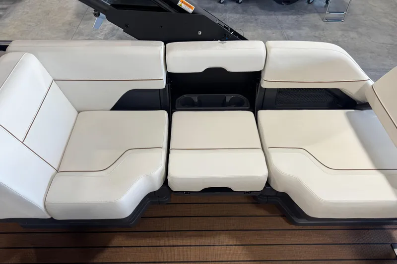 Slide: The Image of Luxurious seating on 2025 Manitou 26 Explore boat, featuring sleek white upholstery. - 8