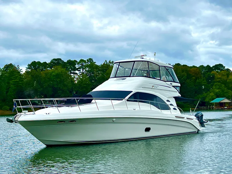 Slide: The Image of 2009 Sea Ray 58 Sedan Bridge yacht cruising on a scenic lake. - 3