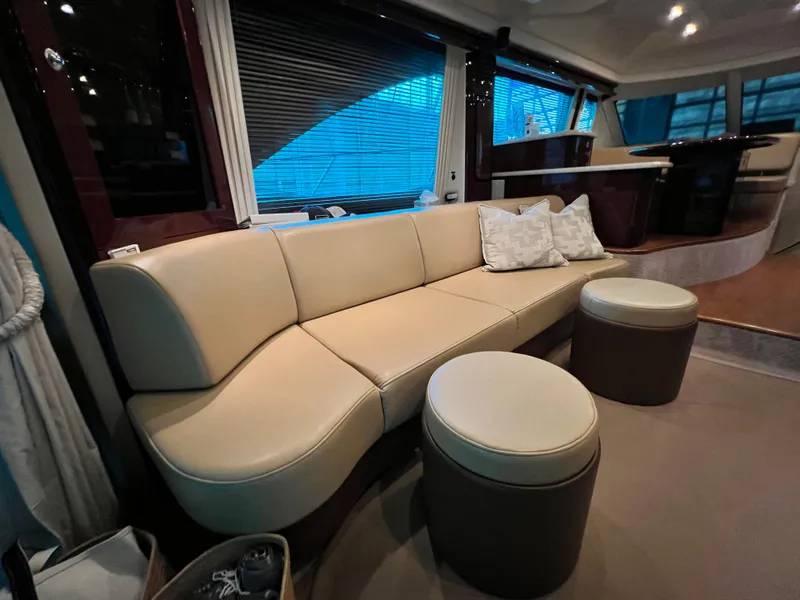 Slide: The Image of 2009 Sea Ray 58 Sedan Bridge yacht cruising on a scenic lake with forested shoreline. - 5