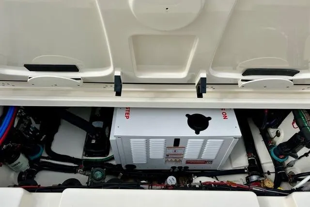 Slide: The Image of 2021 Boston Whaler 345 Conquest Pilothouse engine compartment with visible components and wiring. - 11