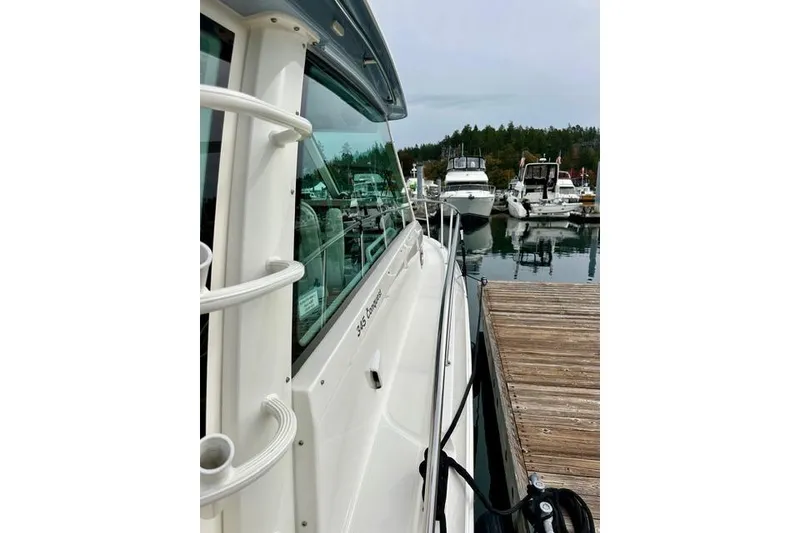 Slide: The Image of Boston Whaler 345 Conquest Pilothouse 2021 docked at marina, side view. - 14