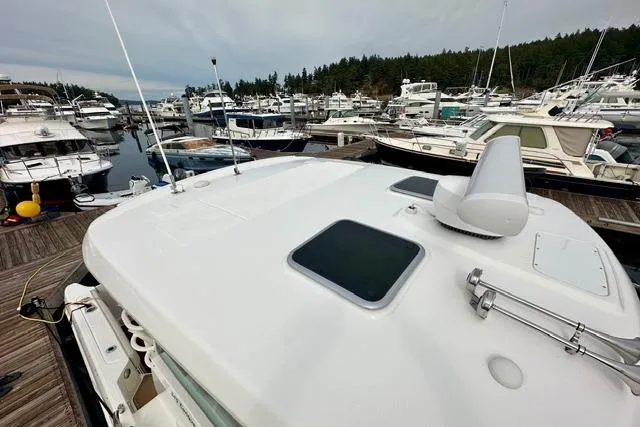 Slide: The Image of 2021 Boston Whaler 345 Conquest Pilothouse docked in a marina with multiple boats. - 16