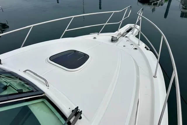Slide: The Image of 2021 Boston Whaler 345 Conquest Pilothouse boat deck with railing and hatch. - 18