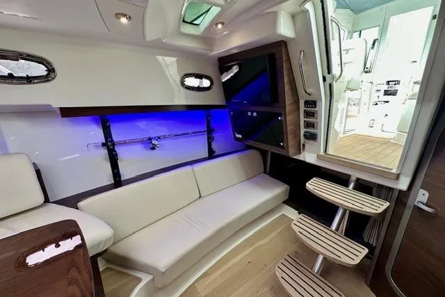 Slide: The Image of Interior of 2021 Boston Whaler 345 Conquest Pilothouse with modern seating and ambient lighting. - 21