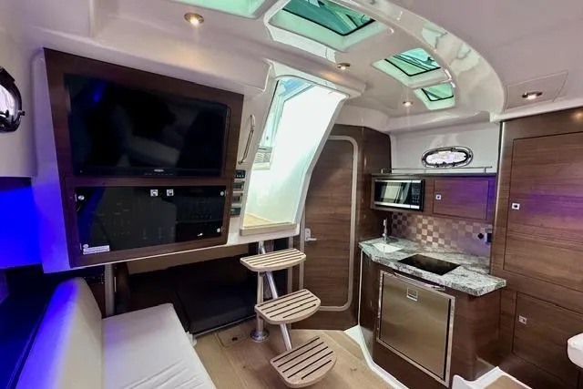 Slide: The Image of Interior of 2021 Boston Whaler 345 Conquest Pilothouse with modern kitchen and seating area. - 22