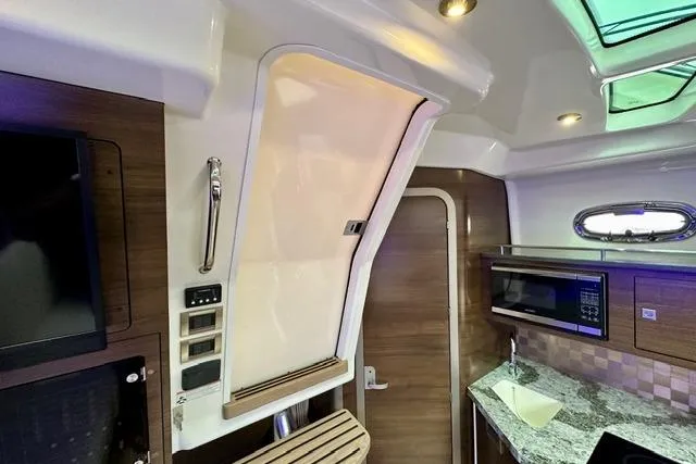 Slide: The Image of Interior of 2021 Boston Whaler 345 Conquest Pilothouse with modern kitchen amenities. - 25