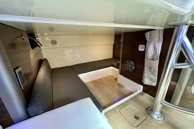 Slide: The Image of Interior cabin of 2021 Boston Whaler 345 Conquest Pilothouse, featuring modern seating and wood flooring. - 27