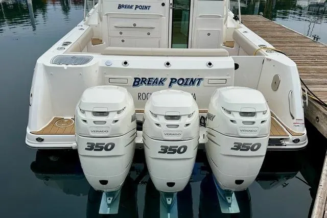 Slide: The Image of 2021 Boston Whaler 345 Conquest Pilothouse with triple 350 Verado engines docked. - 3