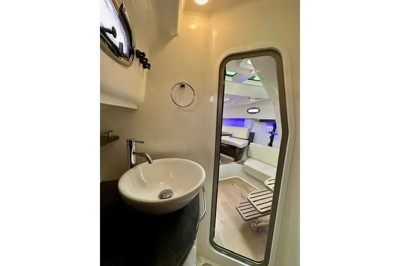 Slide: The Image of Interior of 2021 Boston Whaler 345 Conquest Pilothouse, featuring modern sink and seating area. - 33