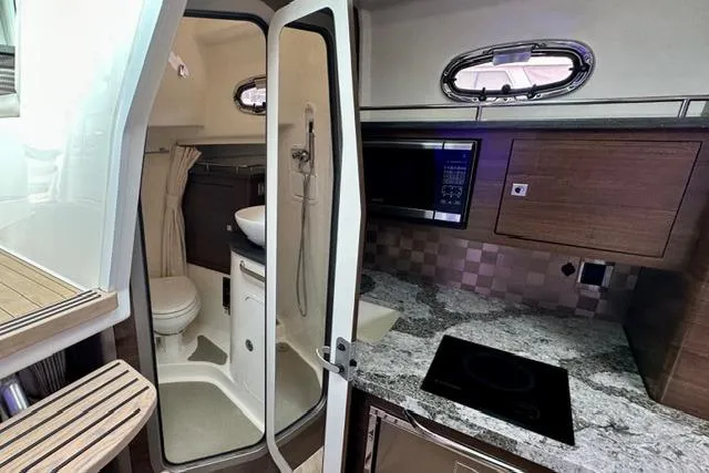 Slide: The Image of Interior of 2021 Boston Whaler 345 Conquest Pilothouse with kitchenette and compact bathroom. - 35