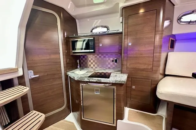 Slide: The Image of 2021 Boston Whaler 345 Conquest Pilothouse interior with modern kitchen amenities. - 36