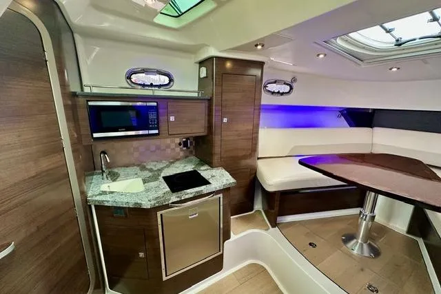 Slide: The Image of Luxurious interior of 2021 Boston Whaler 345 Conquest Pilothouse with modern kitchen and seating area. - 37
